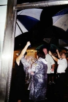 Guests laugh as they enjoy the rain