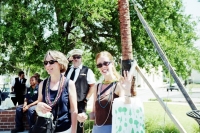Two girls smile & wave