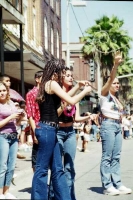 Young Latinas wave to caravan